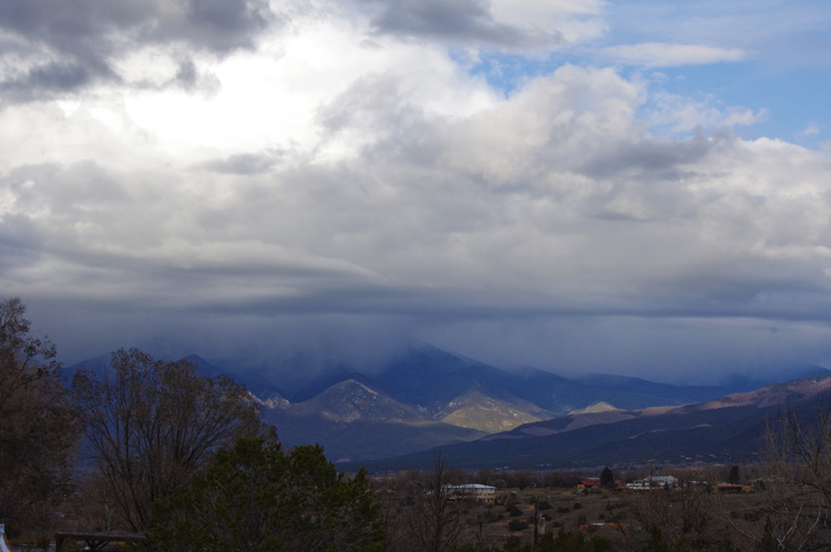 clouds moving in over Taos Mountain