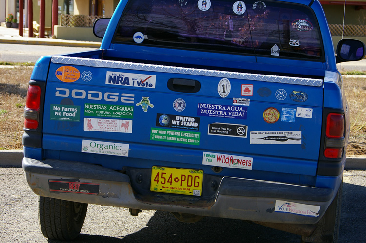 A seemingly self-contradictory bumper sticker display in Taos, New Mexico.