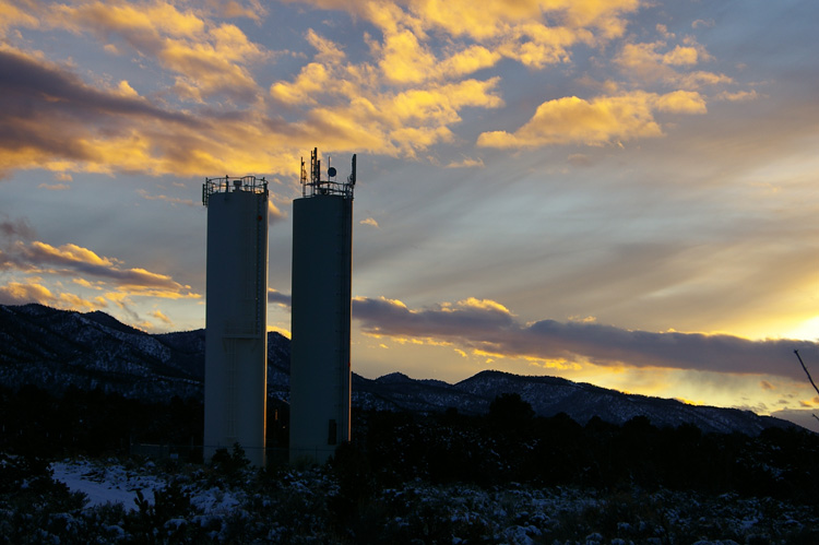 water towers and mountains at sunset