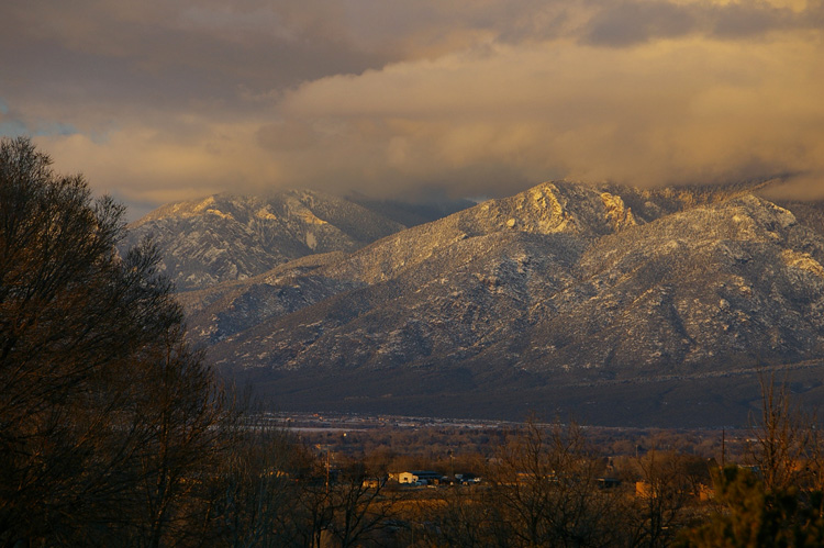 A beautiful shot of El Salto and Taos Mountain in the clouds just before sunset